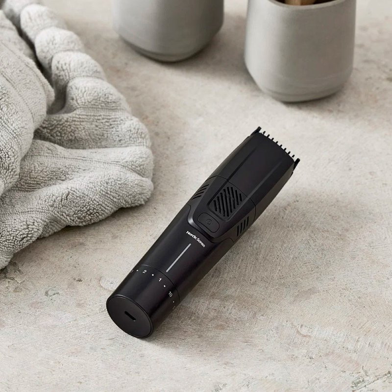 Beard trimmer with vacuum function